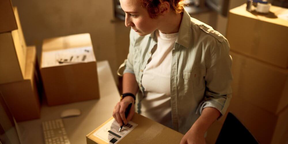 Młoda kurierka w punkcie nadań i odbioru